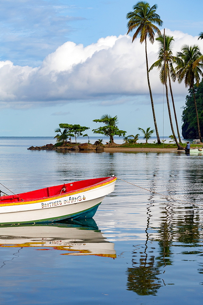 Traditional fishing boat moored at Marigot Bay with tall palms on the small beach in the distance, St. Lucia, Windward Islands, West Indies Caribbean, Central America