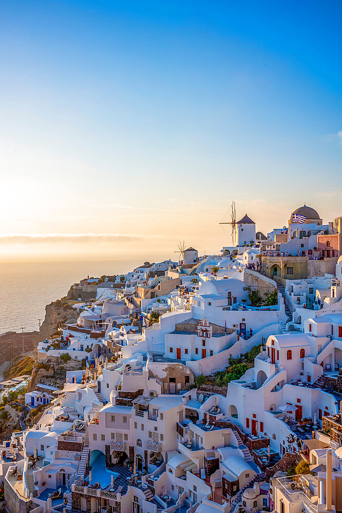 Sunset over windmills, Oia, on the clifftop overlooking the caldera, Santorini, The Cyclades, Aegean Sea, Greek Islands, Greece, Europe