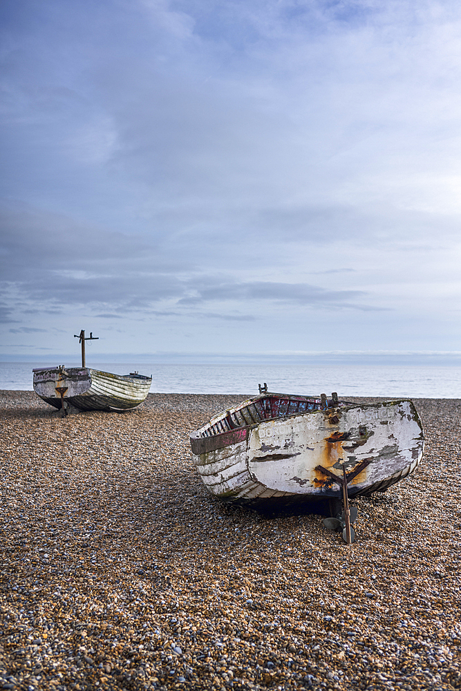 Old traditional fishing boats on the shingle beach at Aldeburgh, in the county of Suffolk, United Kingdom