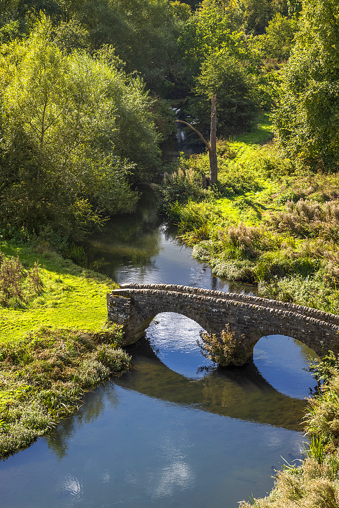 Ancient bridge over a river in the grounds of the historic Haddon Hall, United Kingdom