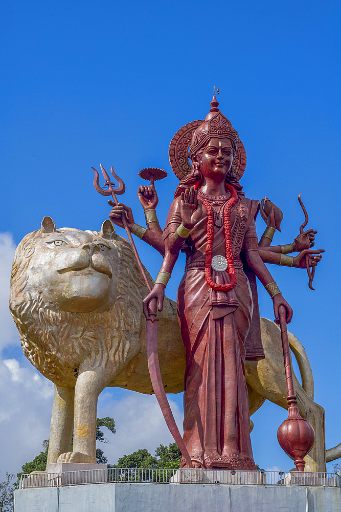 The 33 meter high statue of the Hindu goddess Maa Durga with a golden lion, at the entrance to the Grand Bassin Temple on the exotic island of Mauritius in the Indian Ocean.