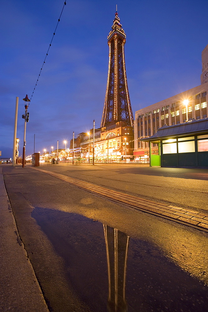 Blackpool Tower reflected in puddle at dusk, Blackpool, Lancashire, England, United Kingdom, Europe