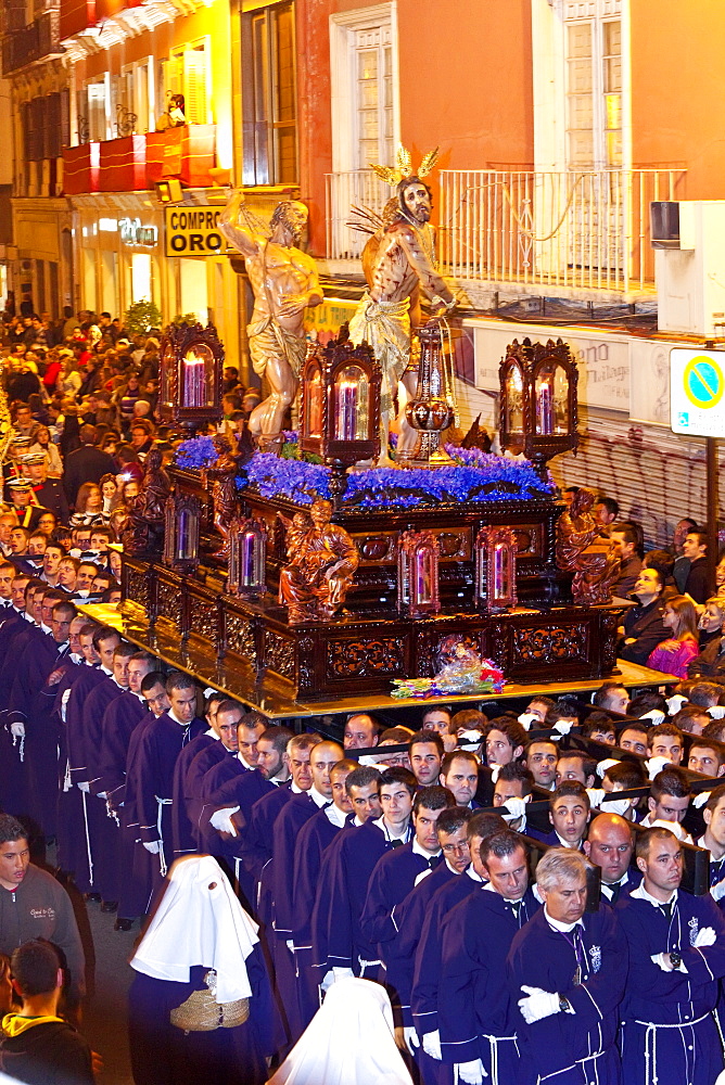 Religious float being carried through the streets during Semana Santa (Holy Week) celebrations, Malaga, Andalucia, Spain, Europe