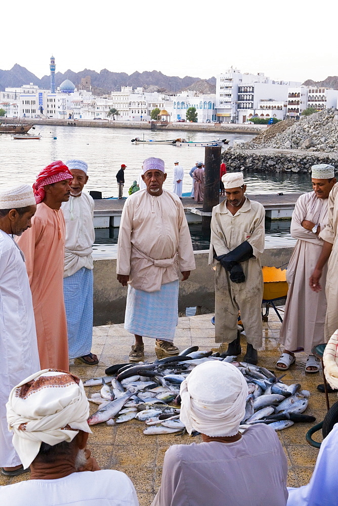 Morning fish market and city skyline, Mutrah, Muscat, Oman, Middle East