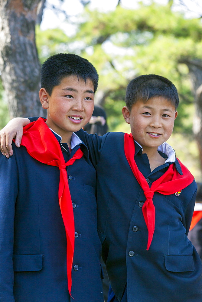 Two boys in Kaeson Park during celebrations for Kim Il Sung's 100th Anniversary on April 15th 2012, Pyongyang, Democratic People's Republic of Korea (DPRK), North Korea, Asia