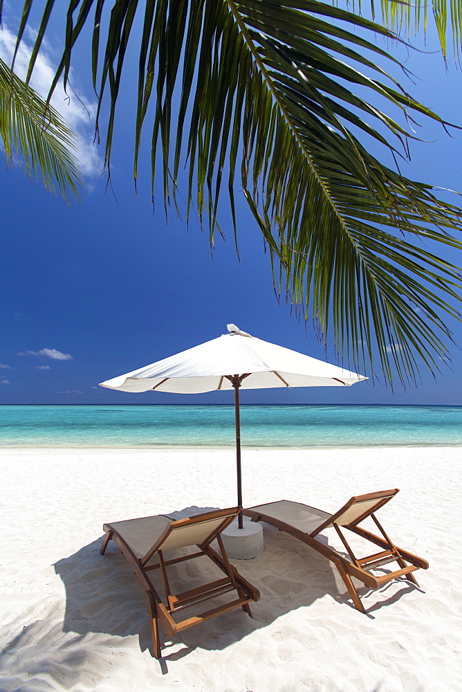 Lounge chairs on tropical beach, Maldives, Indian Ocean, Asia