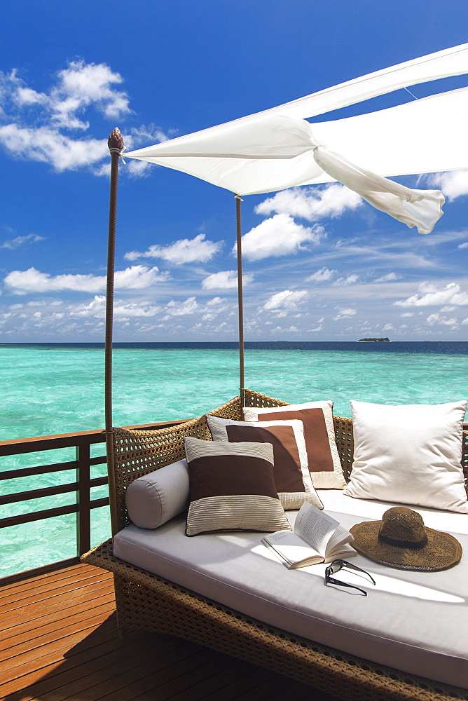 Sofa overlooking ocean, Maldives, Indian Ocean, Asia