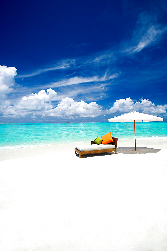 Sofa and parasol on tropical beach, The Maldives, Indian Ocean, Asia