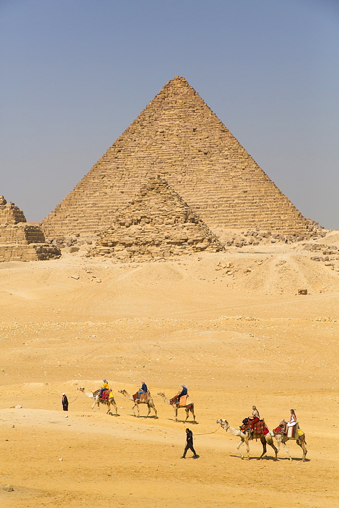 Tourists riding camels, Great Pyramids of Giza, UNESCO World Heritage Site, Giza, Egypt, North Africa, Africa