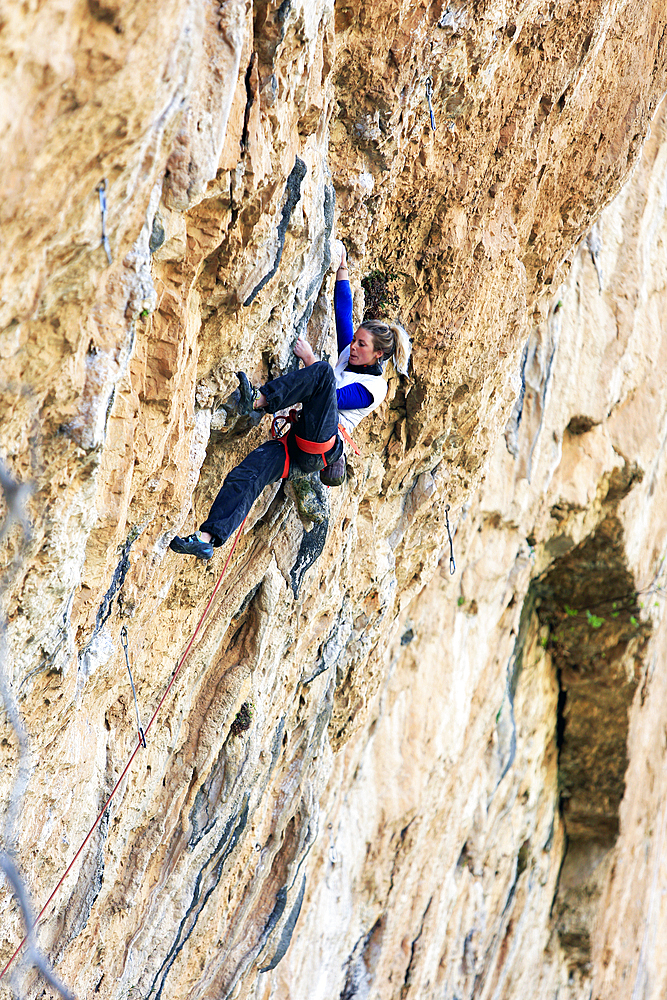 Rock climber in action on the world-famous limestone cliffs of Chulilla, Valencia region, Spain