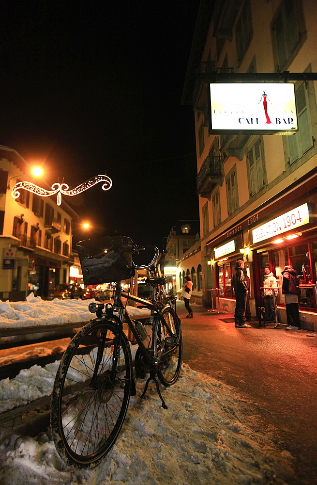 A bicycle propped up against a ski-rack outside the famous Elevation 1904 bar, central Chamonix, Haute Savoie, Alps, France, Europe