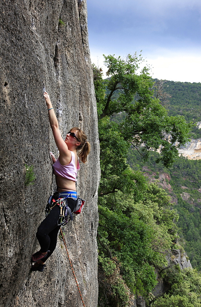 A woman climbing on limestone cliffs near Siurana, a village near Reus and Barcelona, Catalonia, Spain, Europe