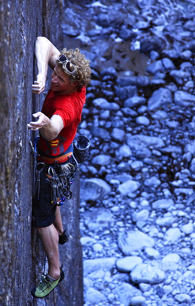 A climber tackles a sheer face using tiny fingerholds in Huntsman's Leap, near Bosherston and St. Govan's Head, Pembrokeshire Coast National Park, South Wales, Wales, United Kingdom, Europe