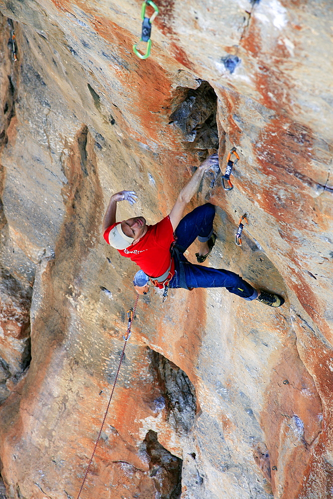 A climber scales cliffs near San Vito Lo Capo, northwest Sicily, Italy, Europe