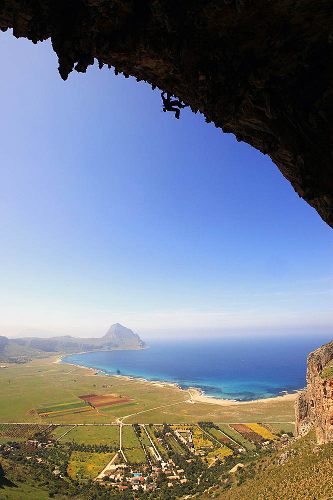 A climber scales cliffs near San Vito Lo Capo, northwest Sicily, Italy, Europe