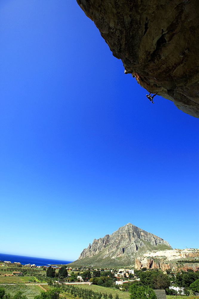 A climber scales cliffs near San Vito Lo Capo, northwest Sicily, Italy, Europe