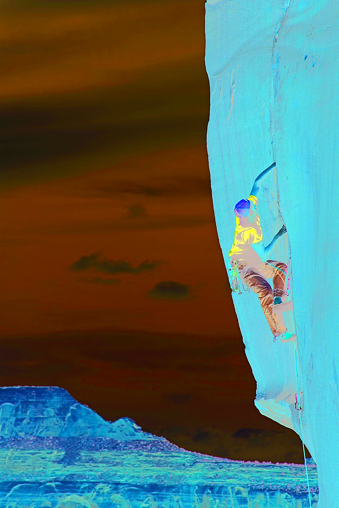 A climber scales cliffs at Indian Creek, Utah, United States of America, North America