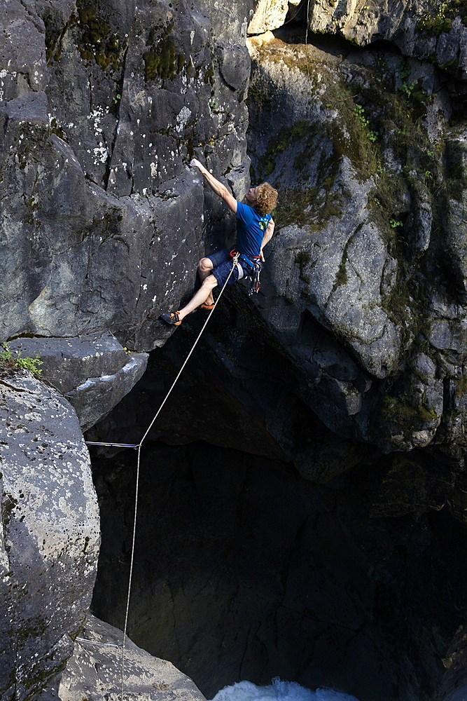 A climber tackles an overhang above Nairn Falls, near Pemberton, British Columbia, Canada, North America