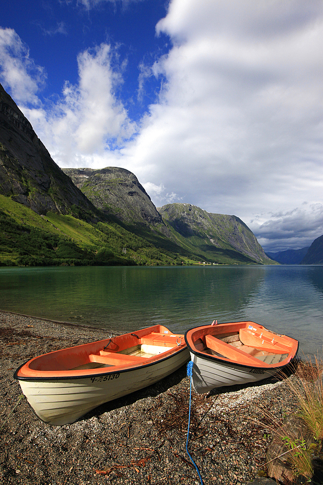 Boats pulled up on the shore of a fjord in the Fjordland region, western Norway, Scandinavia, Europe