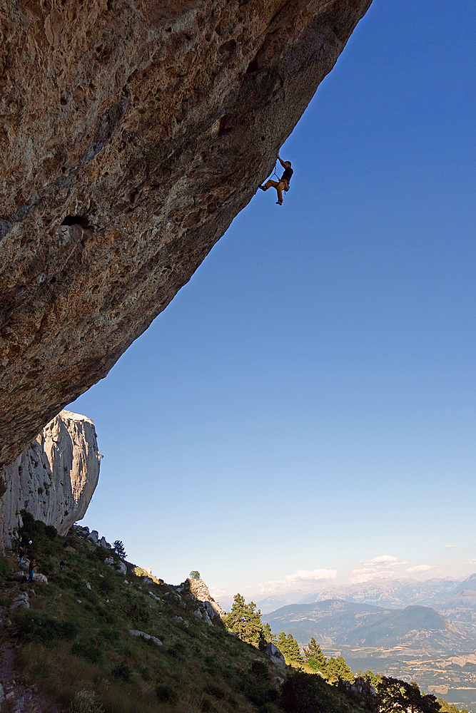 A climber ascends a difficult route on the cliffs of Ceuse, a mountain in the Alpes Maritimes, Haute-Alpes, France, Europe