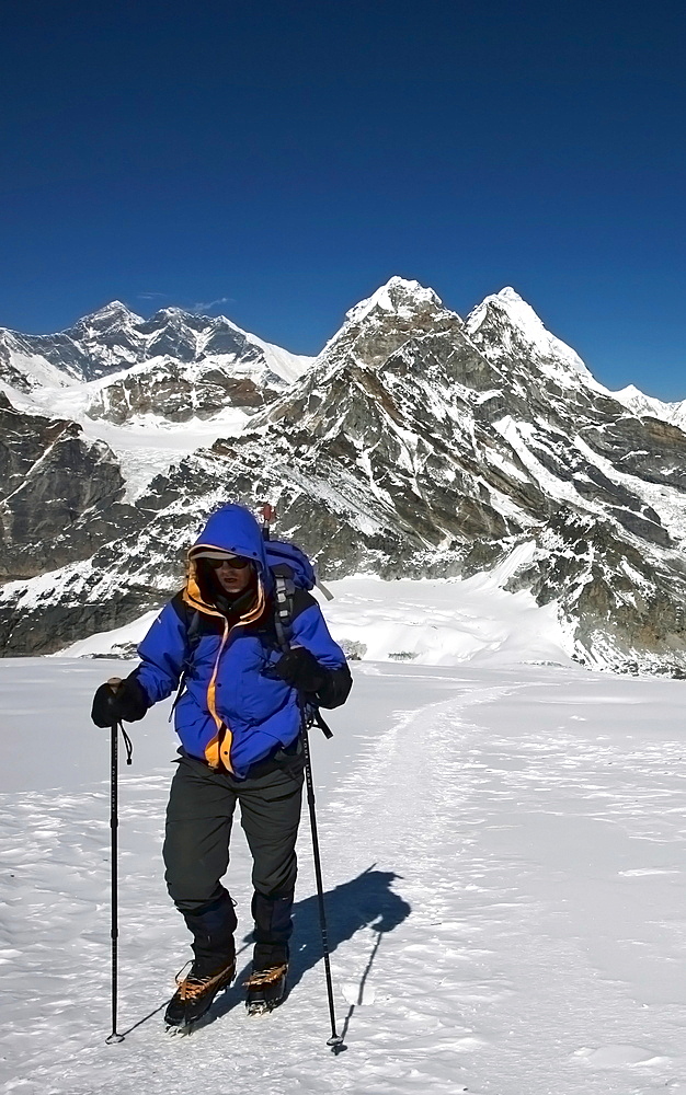 A climber walks towards advanced base camp at 5800 metres on Mera Peak, 6420 metres, a popular trekking peak in the Khumbu region, with Mount Everest beyond, Nepal Himalaya, Nepal, Asia