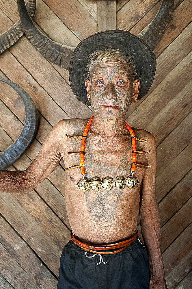 Wangchah Wangsa, Naga headhunter, with tattooed face and tribal necklace, and chest tattoo marking him as having taken heads, Nagaland, India, Asia