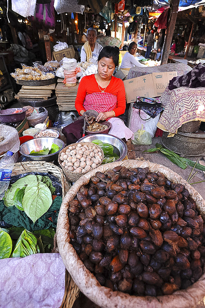 Woman selling nutmeg and other spices in Ima women's market, Imphal, Manipur, India, Asia