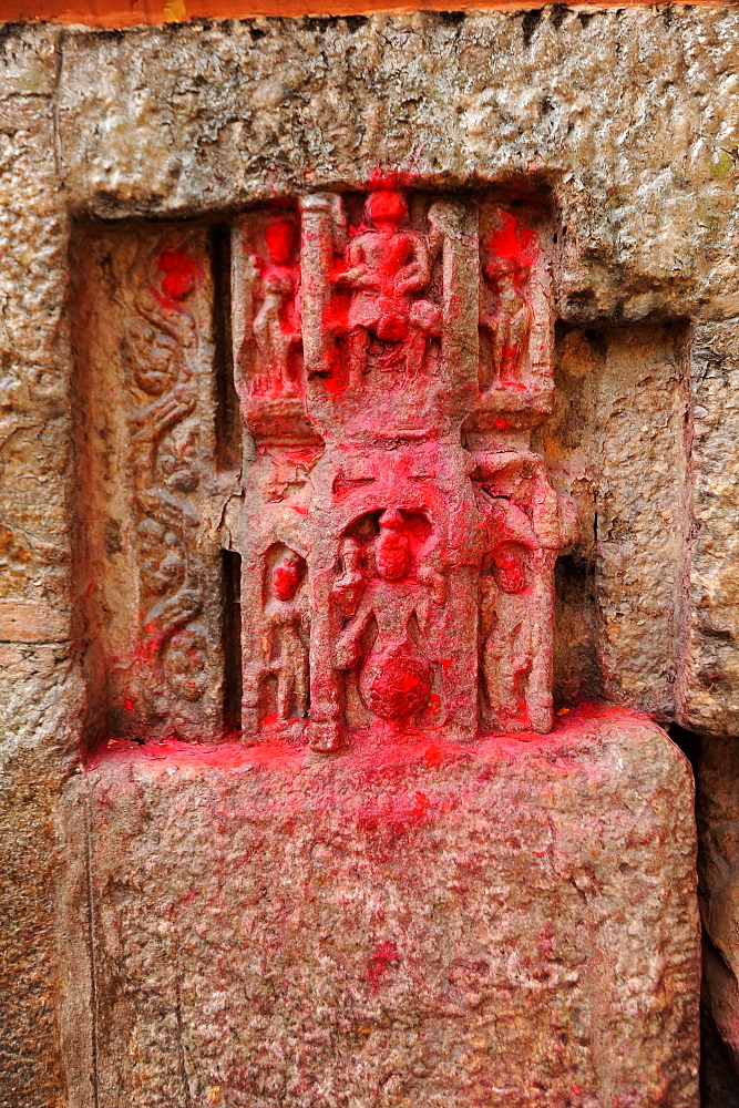 450 year old carvings of gods, blessed with red powder by Hindu pilgrims, in the walls of the Kamakhya temple, Gauhati, Assam, India, Asia