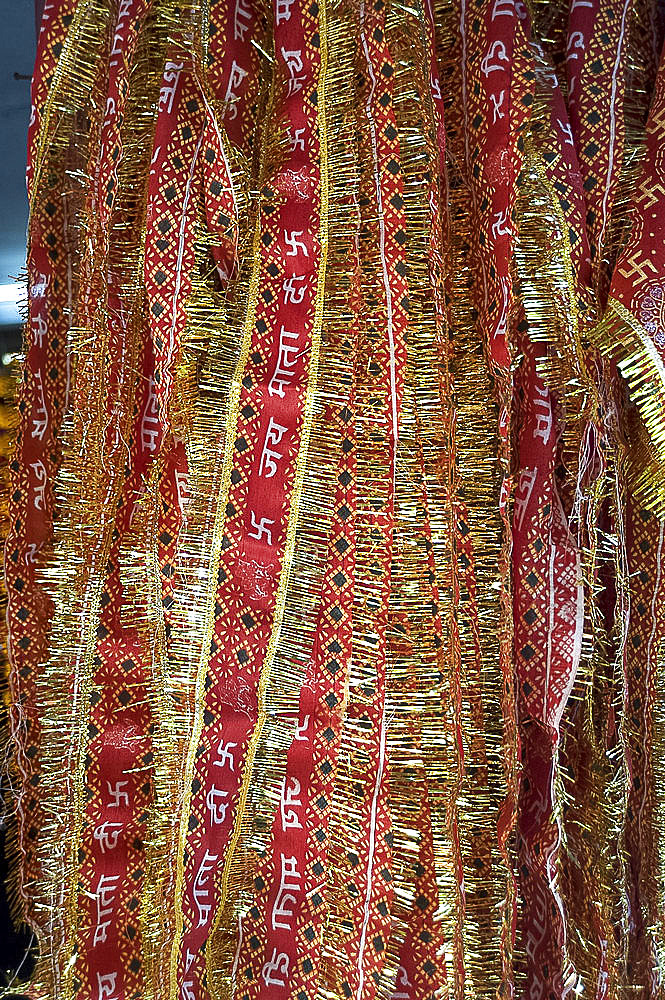 Red and gold tinselled cloths for Hindu devotees visiting a temple, Guwahati, Assam, India, Asia