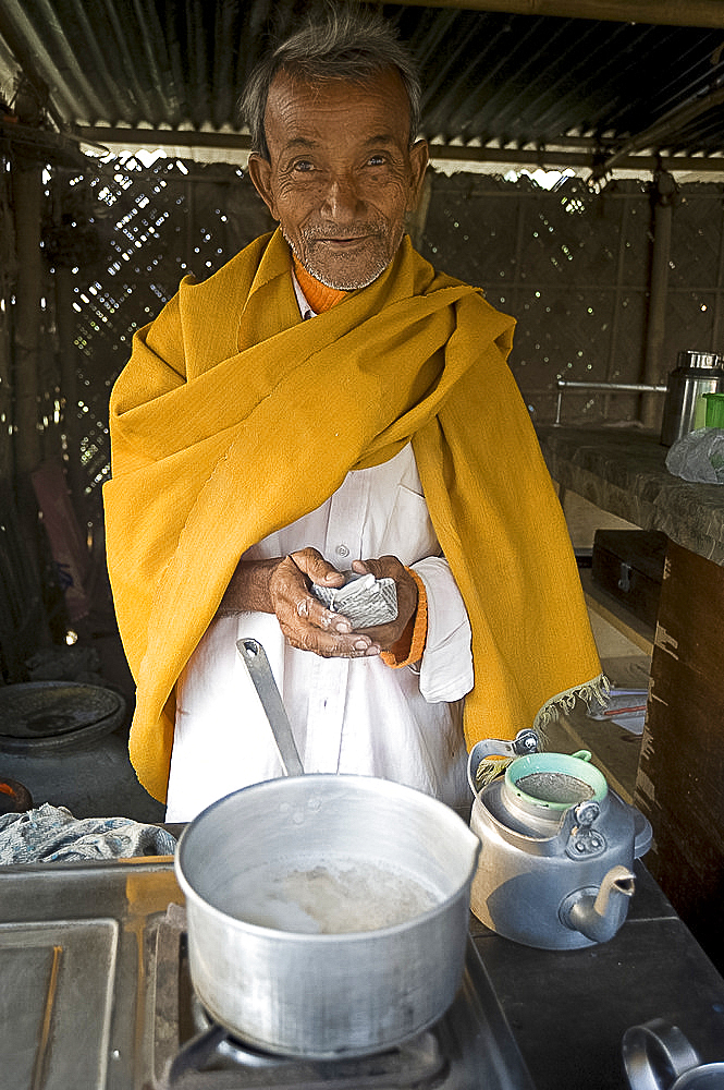 Village chai wallah (teamaker) makes the first brew of the day, Kurua village, Assam, India, Asia