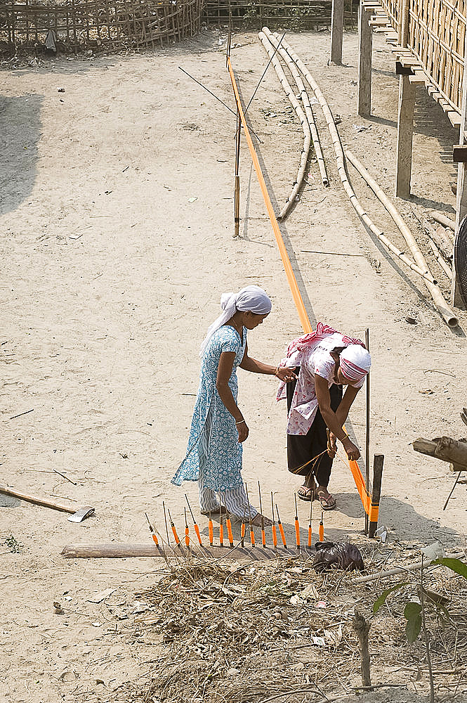 Assamese tribal village women spinning sari length cotton, Majuli Island, Assam, India, Asia