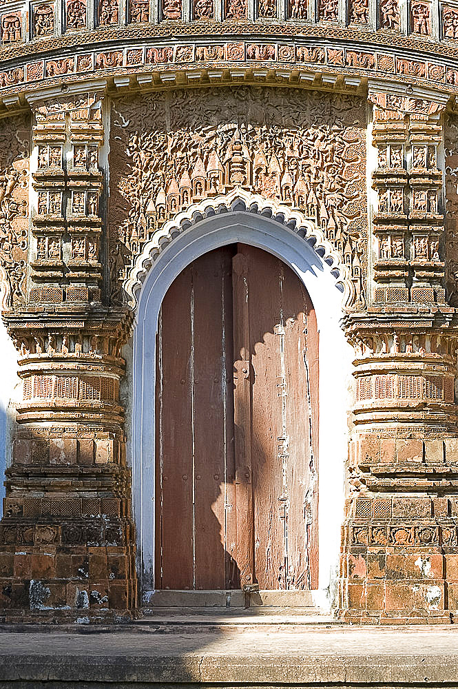 Ornate carving of Hindu myths above a door in the restored miniature terracotta Hindu temple in Baranagar, rural West Bengal, India, Asia