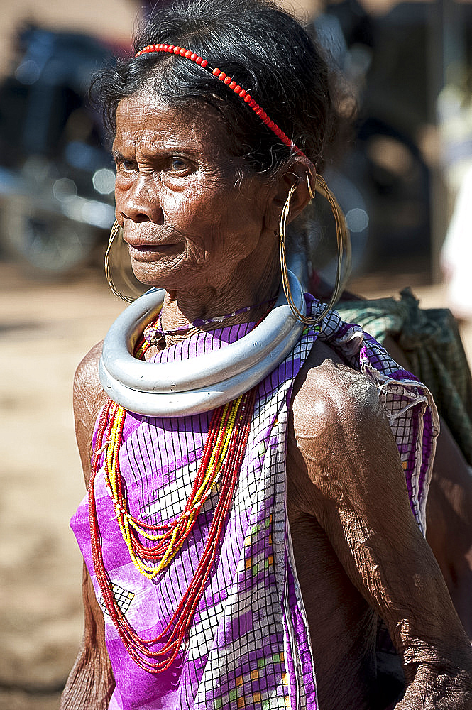 Mature Gadaba tribeswoman with traditional double silver necklaces denoting her tribe, at Bonda tribal street market, Rayagader, Orissa, India, Asia