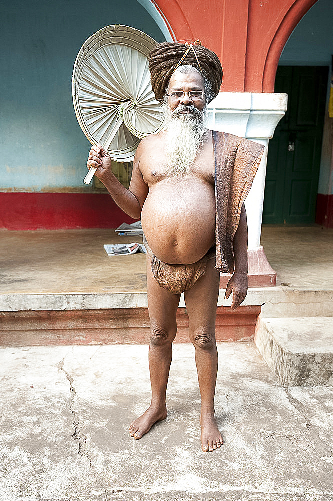 Joranda monk wearing tree bark loincloth, holding palm leaf fan, with uncut hair piled up on top of his head, Joranda, Orissa, India, Asia