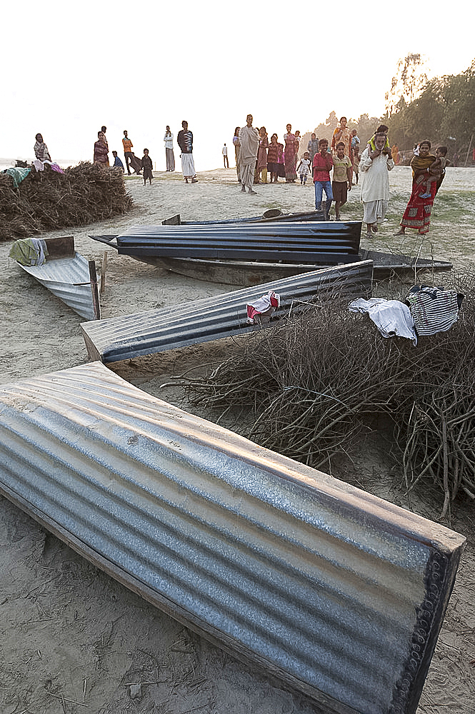 Small boats made from single sheets of corrugated iron, lying on the sandy banks of the River Hugli (River Hooghly), West Bengal, India, Asia