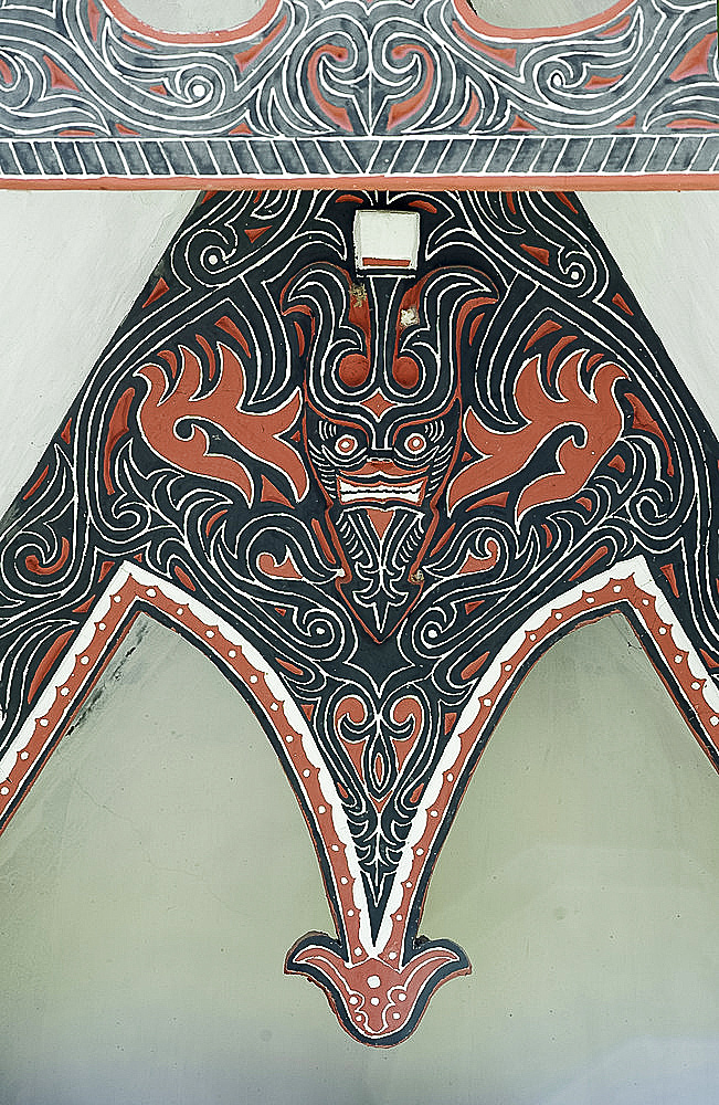 Detail of traditional Batak tribal painted carving with stylised buffalo horns, Huta Bolon, Simanindo, Sumatra, Indonesia, Southeast Asia, Asia