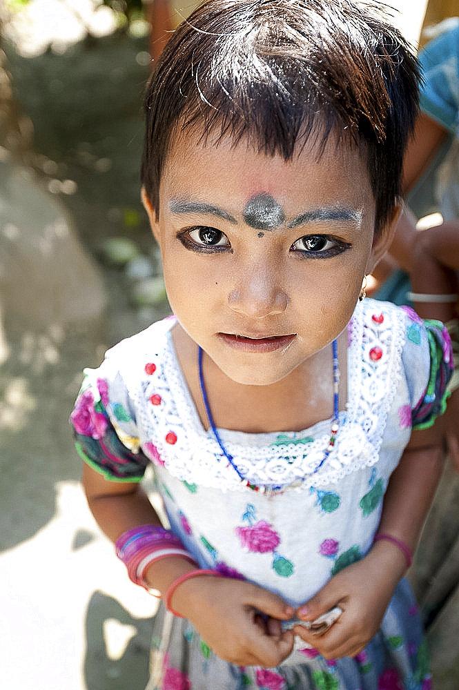 Young village girl of the Bodo tribe, with kohl make-up on eyes and eyebrows, and black dot to ward off evil spirits, Assam, India, Asia