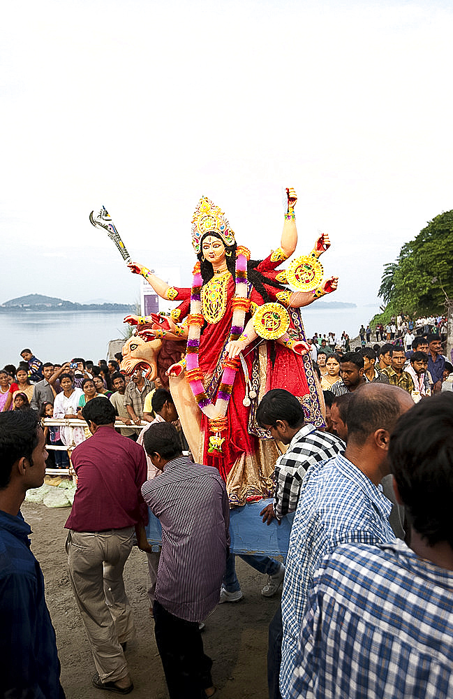 Durga puja deity, made from river mud and decorated, being taken to the Brahmaputra riverbank for Durga puja immersion ceremony, Guwahati, Assam, India, Asia