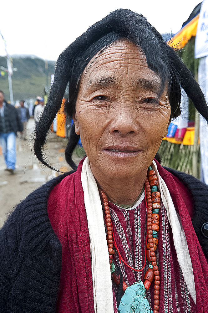 Momba tribeswoman wearing traditional five peak yak's wool felted hat, and coral and turquoise jewellery, Tawang, Arunachal Pradesh, India, Asia