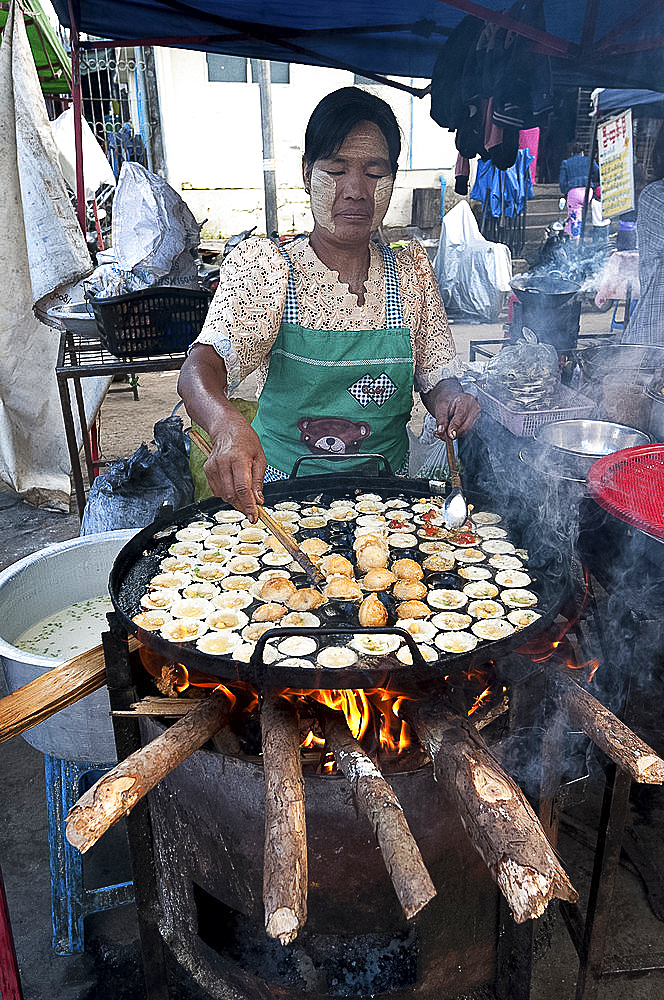 Woman frying tiny chickpea and quails egg fritters on a street market food stall in Pyin Oo Lwyn, Mandalay Division, Myanmar (Burma), Asia