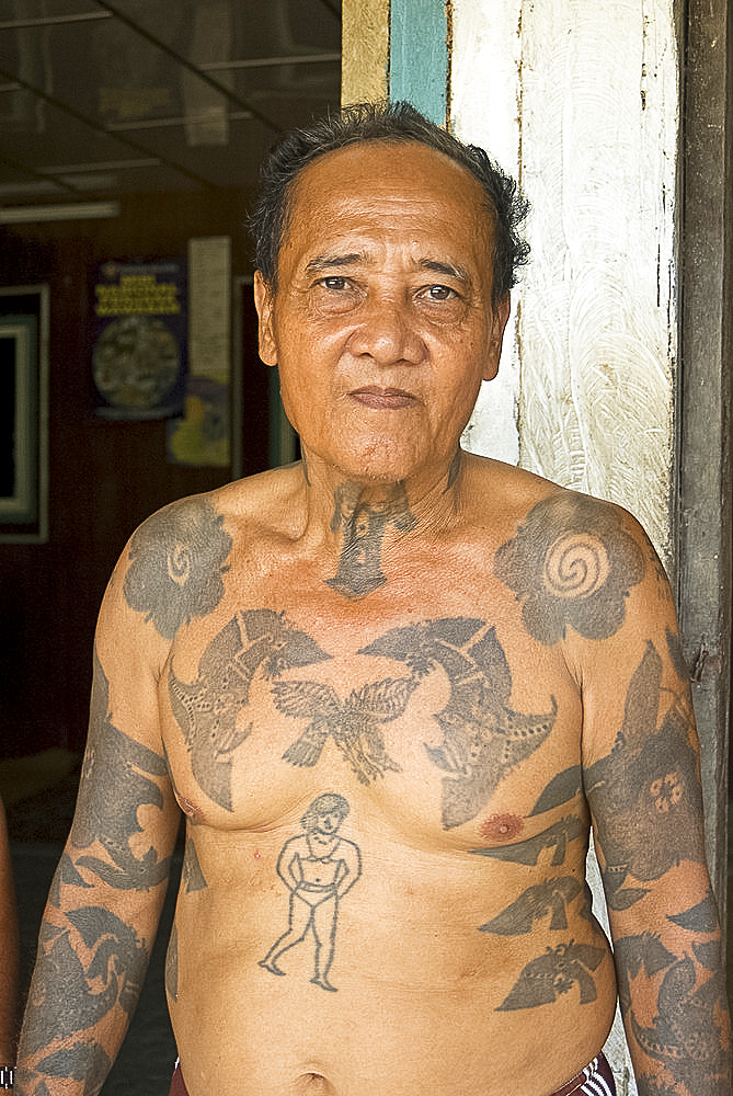 Jugah, an Iban tribal longhouse head man (Tuai Rumah), with traditional warrior tattoos, Kapit district, Sarawak, Malaysian Borneo, Malaysia, Southeast Asia, Asia