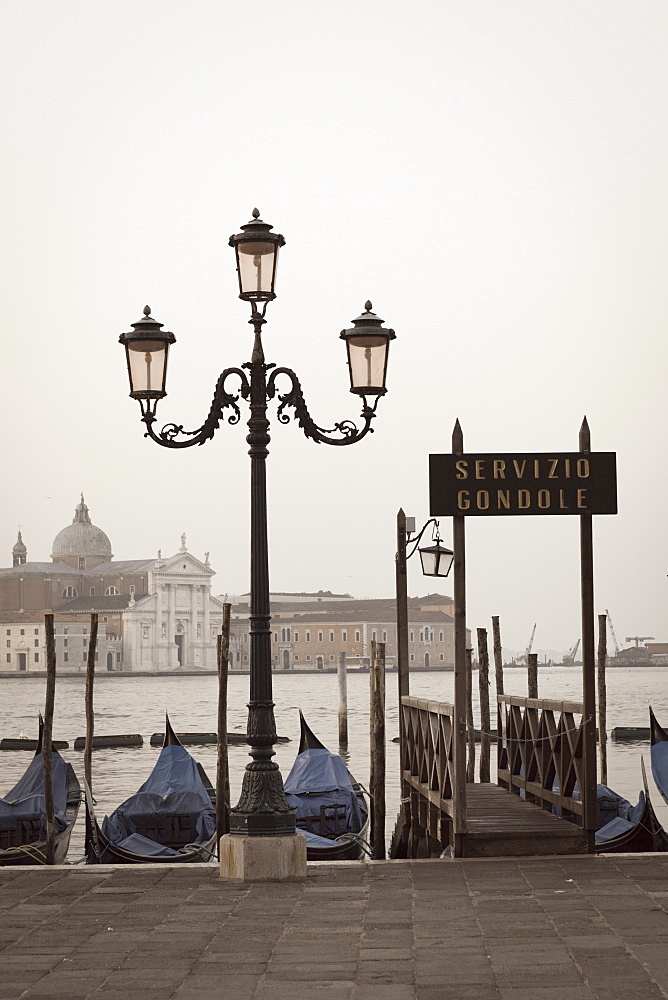 Gondolas moored on the Lagoon, San Giorgio Maggiore beyond, Riva degli Schiavoni, Venice, UNESCO World Heritage Site, Veneto, Italy, Europe