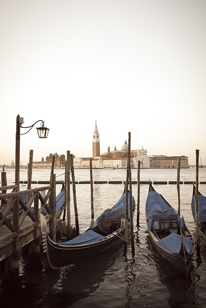 Gondolas moored on the Lagoon, San Giorgio Maggiore beyond, Riva degli Schiavoni, Venice, UNESCO World Heritage Site, Veneto, Italy, Europe