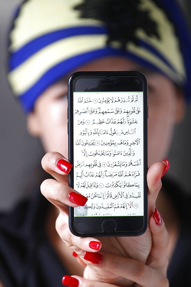 Woman with a digital Quran on a smartphone, Vietnam, Indochina, Southeast Asia, Asia