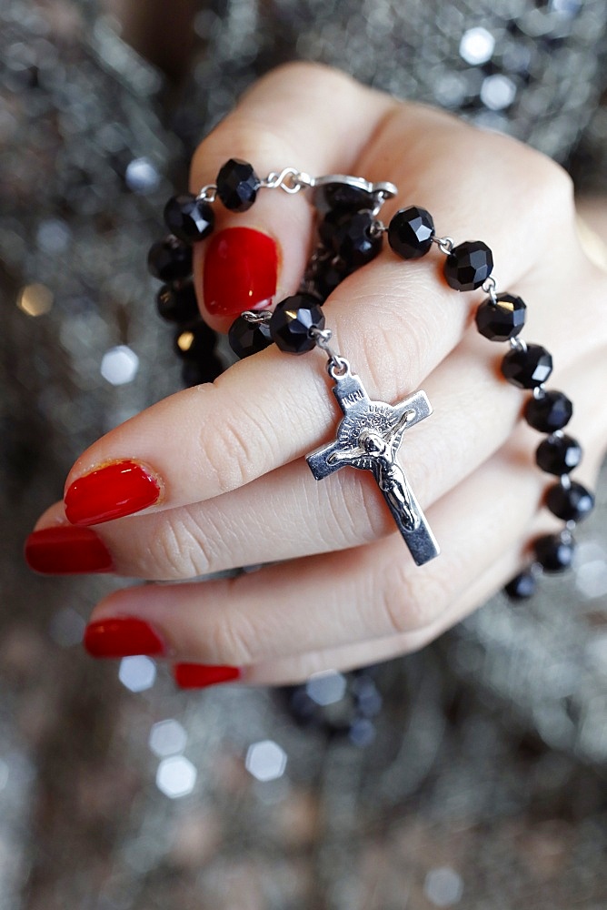 Catholic woman praying rosary beads and crucifix, Vietnam, Indochina, Southeast Asia, Asia