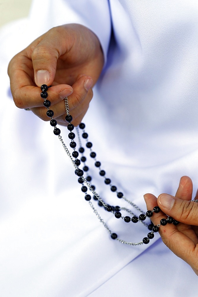 Close-up of hands of Dominican nun praying the rosary beads, Vietnam, Indochina, Southeast Asia, Asia