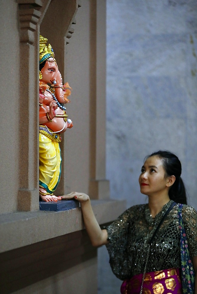 Woman praying to Hindu deity Ganesh statue, Sri Mahamariamman Hindu Temple, Kuala Lumpur, Malaysia, Southeast Asia, Asia