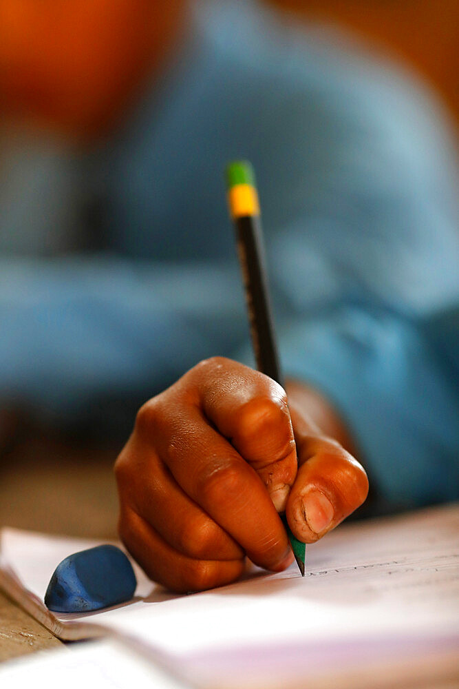 Primary school, boy in classroom, close-up on pencil, concept of education and school life, Kathmandu, Nepal, Asia