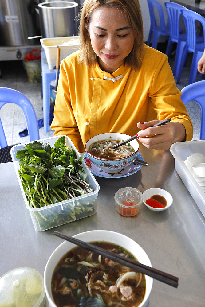 Woman eating traditional Vietnamese soup Pho, Tan Chau, Vietnam, Indochina, Southeast Asia, Asia