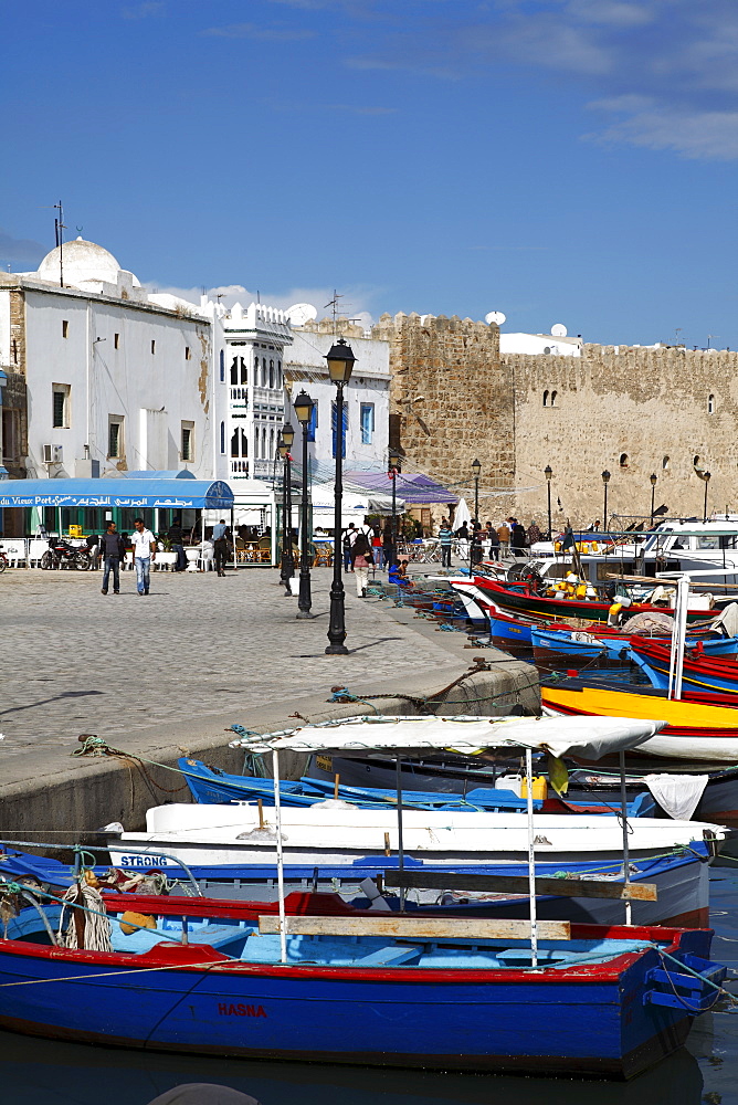 Fishing boats, old port canal with kasbah wall in background, Bizerte, Tunisia, North Africa, Africa